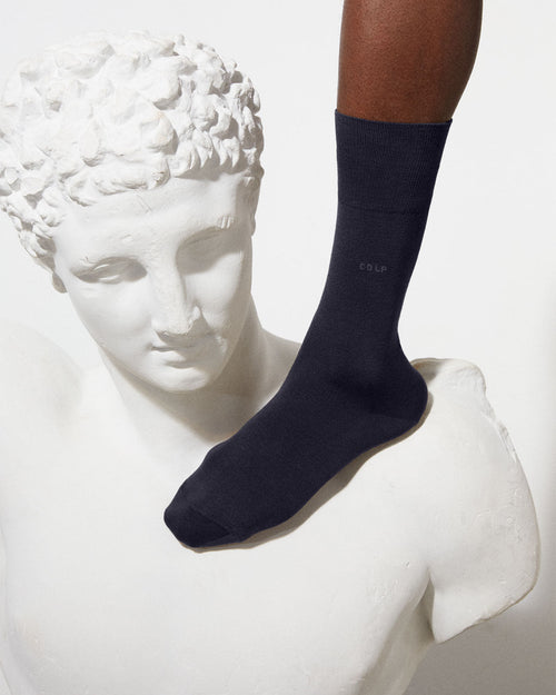 Model wearing Unisex Mid Length Cotton Socks in Dark Navy - CDLP