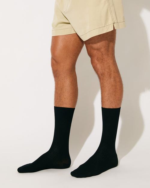 Model wearing Unisex Mid Length Cotton Socks in Black - CDLP