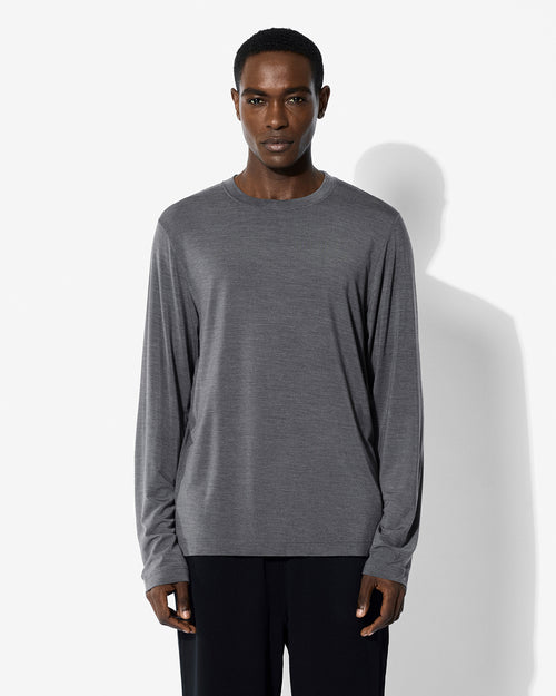 A model wearing the CDLP Merino Blend Long Sleeve T-Shirt in Grey Melange.