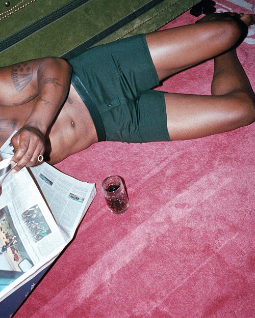 Marcus reading the paper wearing Boxer Shorts in Army green