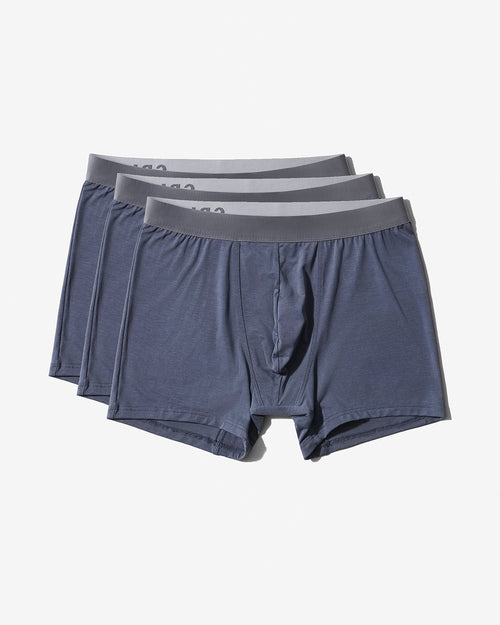 Three pairs of men's boxer briefs in a heathered slate blue-gray color, stacked slightly offset to show the waistbands, on a clean off-white background.
