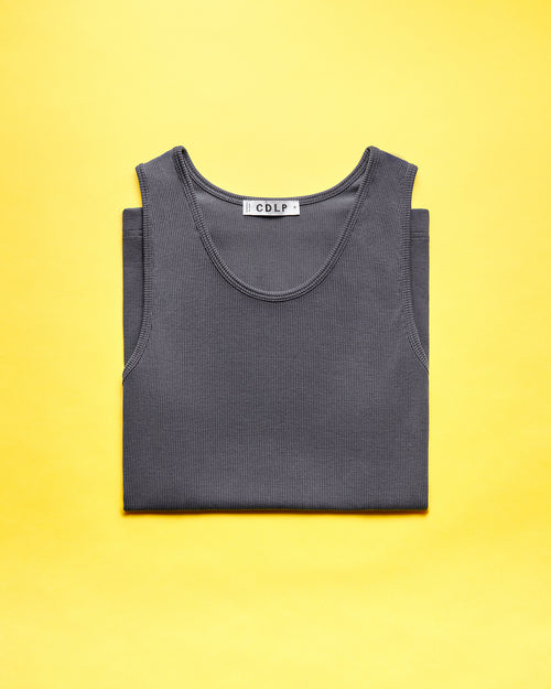 A folded dark grey ribbed tank top with a visible CDLP brand label on a yellow background.