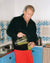 Dolph Lundgren pouring smoothie wearing Heavy Terry Half-Zip in Black