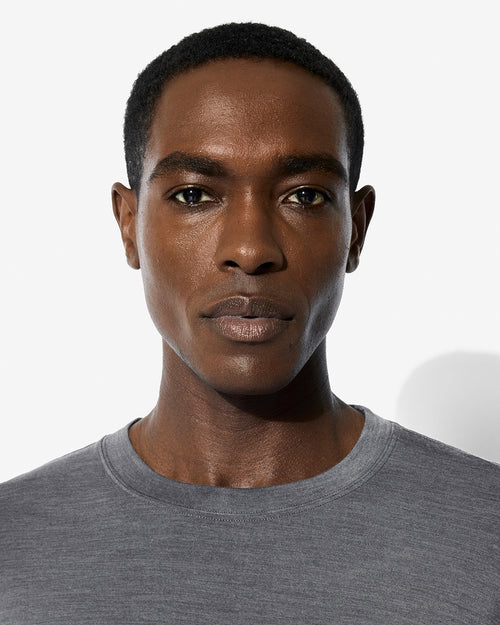 A model wearing our Merino Blend Long Sleeve T-Shirt in Grey Melange.