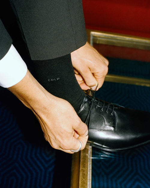 Tying shoes in Mid-Length Socks in Black