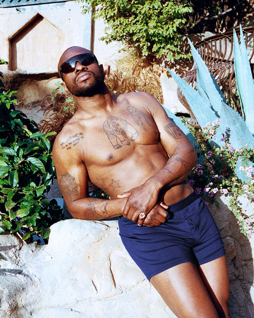 Marcus posing in the sun while wearing Boxer Shorts in Navy Blue