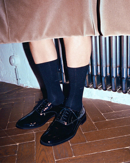 Oskar wearing black shoes and Mid-Length Socks in Navy Blue