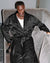 Edrisa sitting on the couch in Black Home Robe