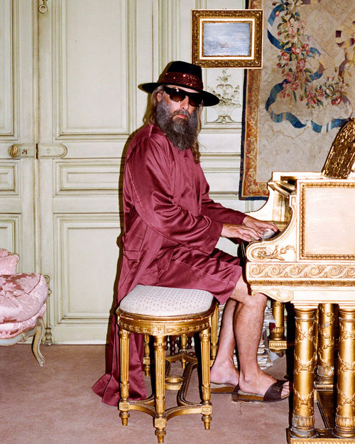 Sébastien playing the piano while wearing Home Robe in Burgundy